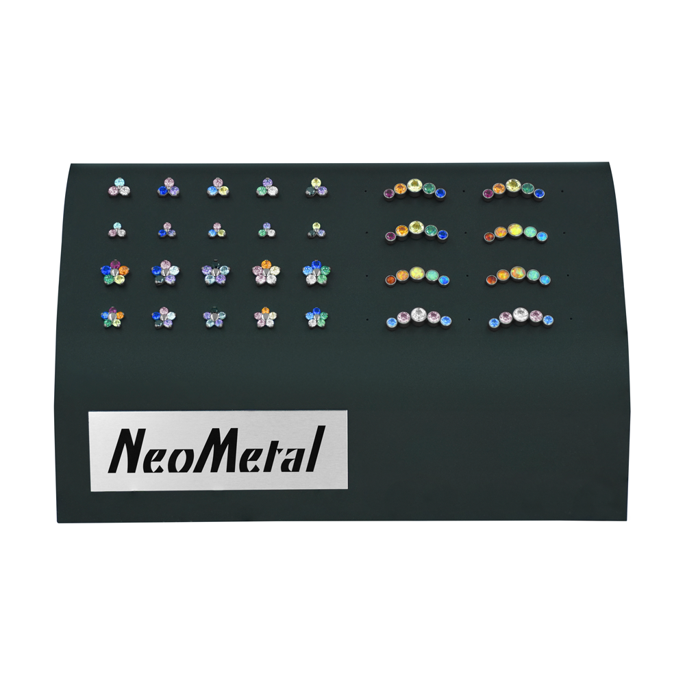A black acrylic 40-piece gem display featuring all 28 styles and sizes of Pride gems, including Trinities, Flowers, and Clusters